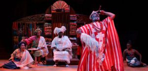 Anthony Santiago (foreground) as Elesin with (from left) Ijeoma Emesowum as Ariyike, Celia Aloma as Olabisi, Akosua Amo-Adem as Iyaloja, and Espoir Segbeaya as Wuraola in Death and the King's Horseman. Photo by David Hou