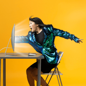 A woman in a sequin coat reaching in a flat screen computer monitor and being sucked in.